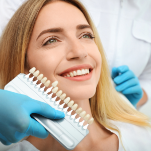Cosmetic dentist improving the smile of a young woman